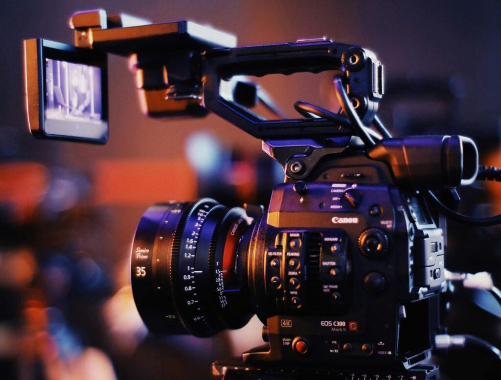 Close-up of a professional video camera setup indoors, capturing high-quality footage.
